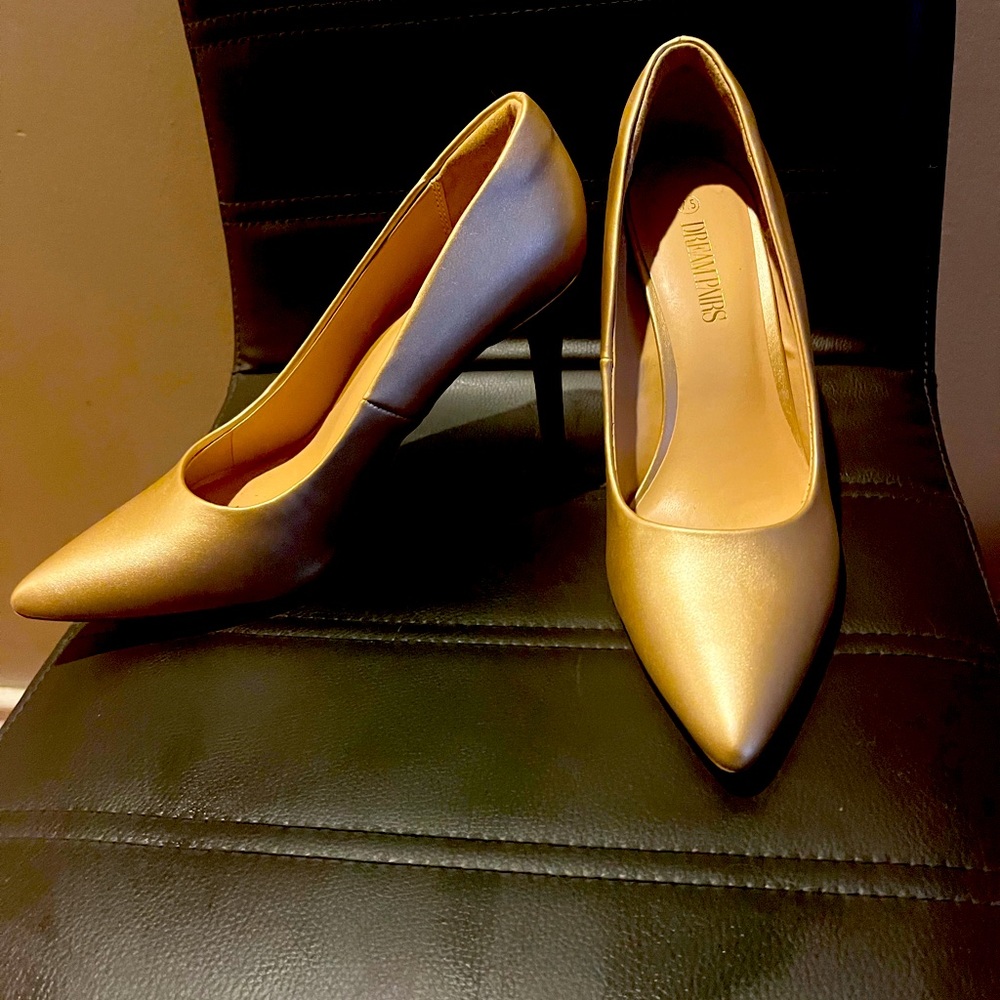 2.5 inch heel. Never worn. Gold pumps